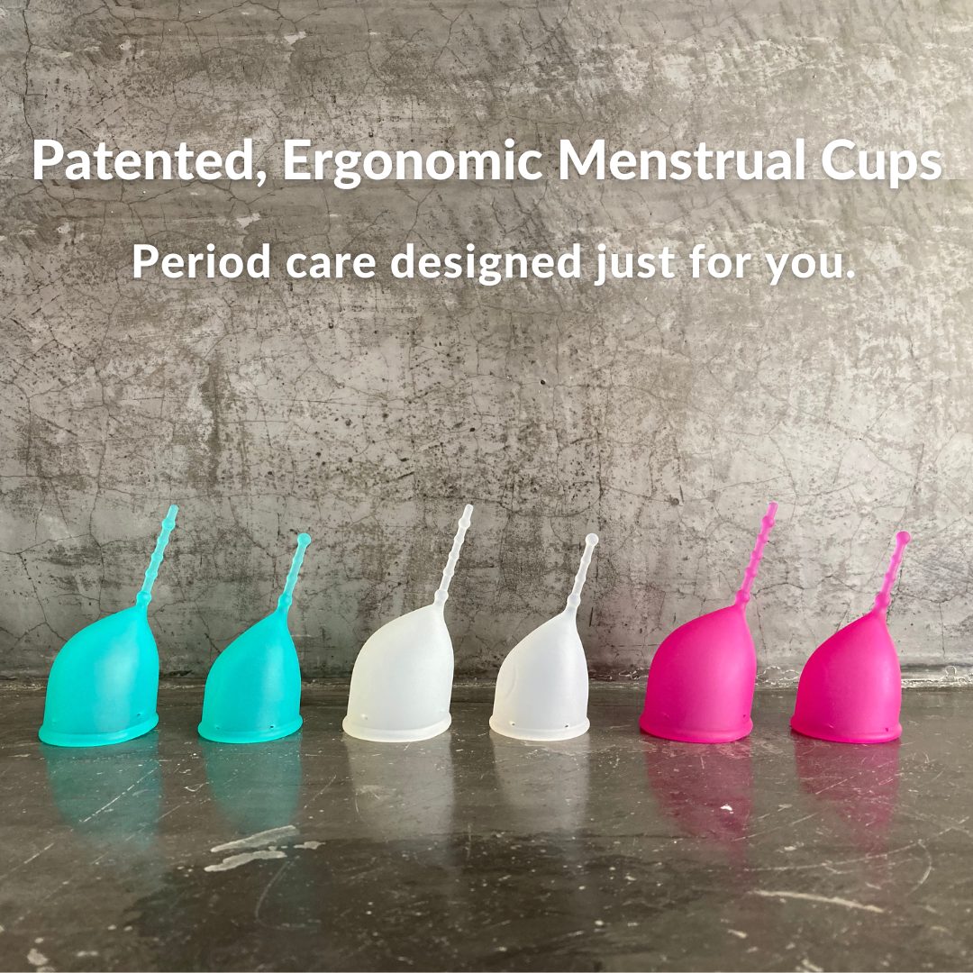 Kind Cup menstrual cups pictured in profile showing patented ergonomic shape and long removal stem. Cups shown in aqua, clear, and violet in both size regular and small. Text: "Patented, ergonomic menstrual cups - period care designed just for you"