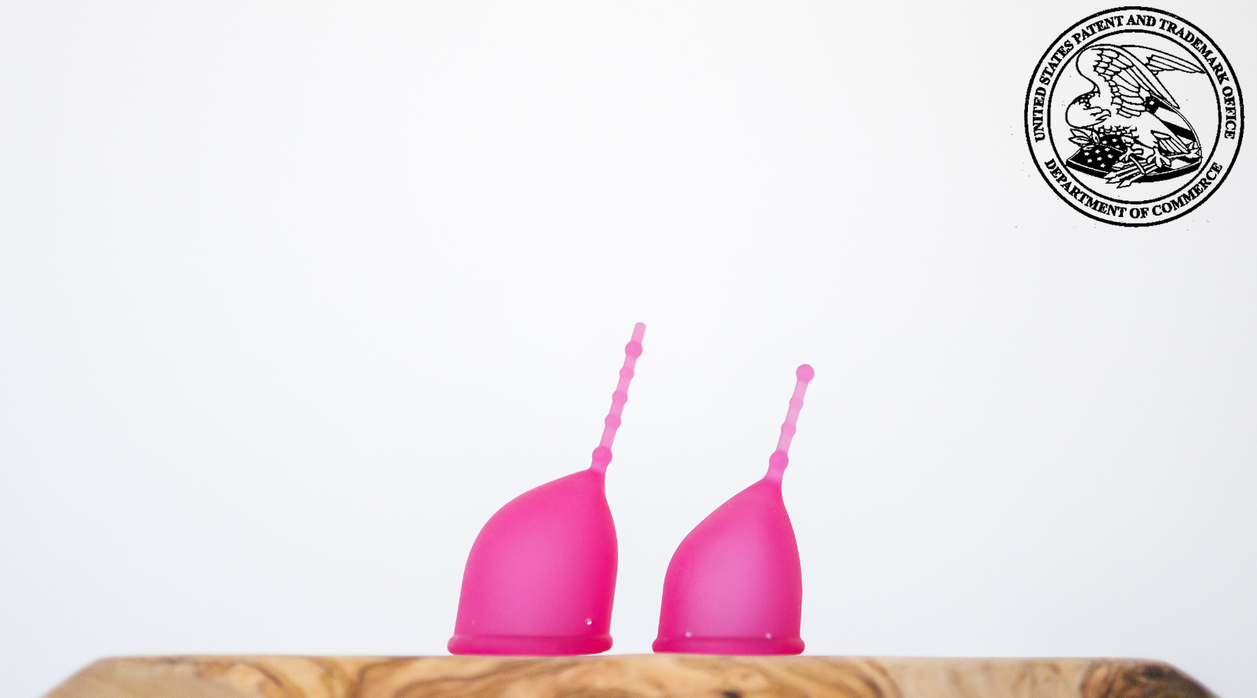 Kind Cup menstrual cups shown in profile with U.S. Patent Office Seal